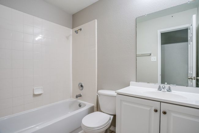 Bathroom featuring toilet, vanity, and shower combination | Image 15