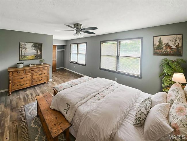 Bedroom with wood finished floors, a closet, and ceiling fan | Image 7