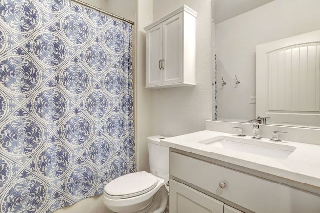 Bathroom featuring vanity, toilet, and a shower with curtain | Image 20