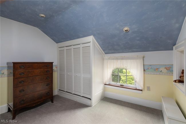 Bedroom with a closet, lofted ceiling, and carpet flooring | Image 37