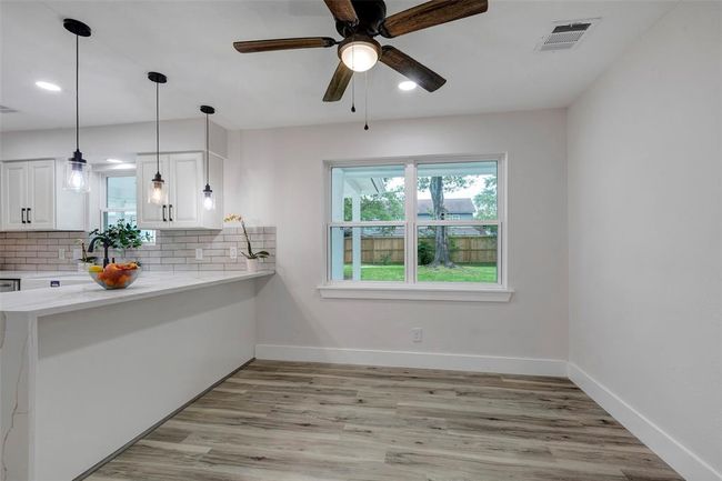 Breakfast area with natural light and ceiling fan and Vinyl flooring. | Image 13