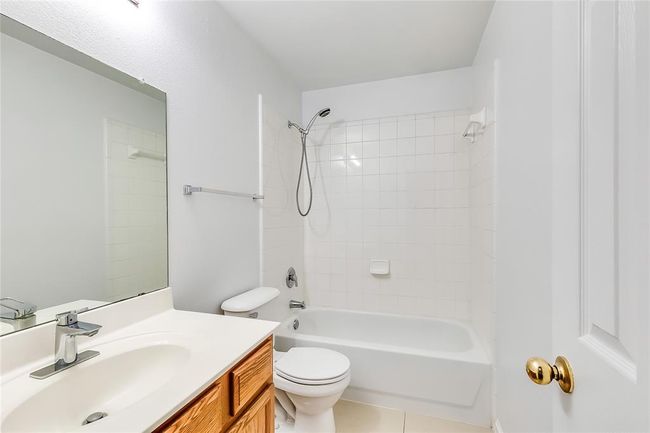 Full bath with vanity, bathtub / shower combination, and tile patterned flooring | Image 18