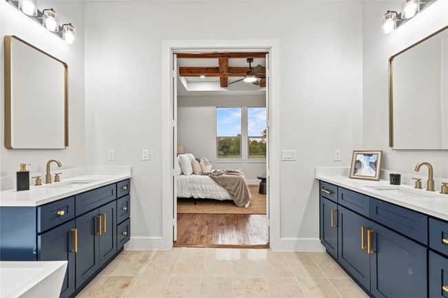 Bathroom with coffered ceiling, two vanities, a ceiling fan, beamed ceiling, and connected bathroom | Image 14