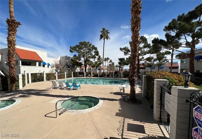 Community pool with a community hot tub, a patio area, and fence | Image 12