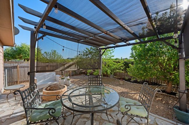 View of patio / terrace featuring a fenced backyard, an outdoor fire pit, outdoor dining area, and a pergola | Image 20