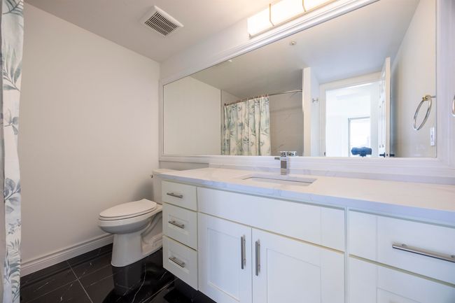 Bathroom featuring vanity and a shower with shower curtain | Image 11