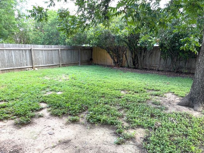 View of fenced backyard | Image 18