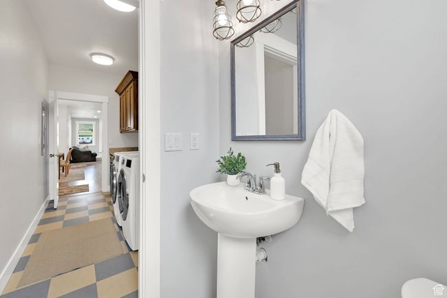 Bathroom featuring independent washer and dryer and tile patterned floors | Image 30