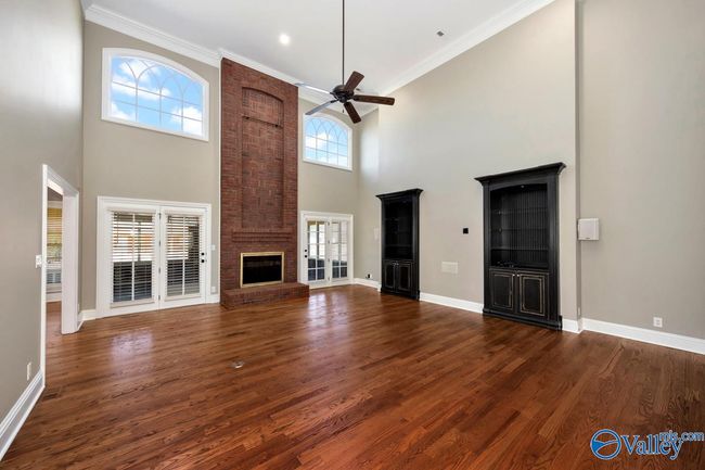 Wood flooring, built in cabinetry, fireplace, extra high ceilings, recessed lighting, crown molding, Double doors open to enclosed porch | Image 5