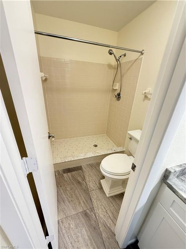 Full bath featuring a shower stall and toilet | Image 16
