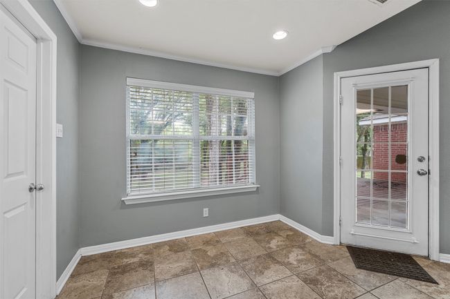Empty room featuring healthy amount of natural light, crown molding, and recessed lighting | Image 6