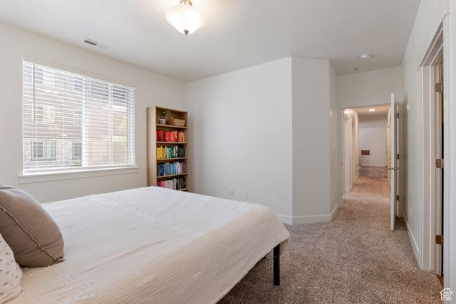 Carpeted bedroom with baseboards | Image 12