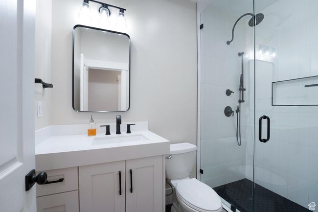 Bathroom featuring a stall shower and vanity | Image 22