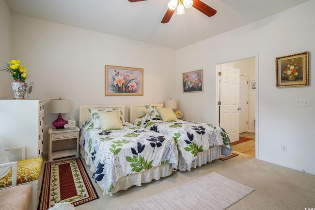 Carpeted bedroom with baseboards and a ceiling fan | Image 19
