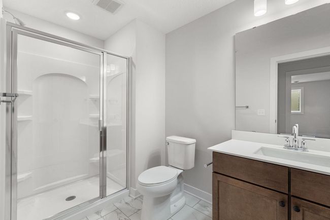 This stylish basement 3/4 bathroom features a modern design with sleek fixtures, a spacious shower, and a spacious vanity, offering both convenience and comfort for family or guests. | Image 36