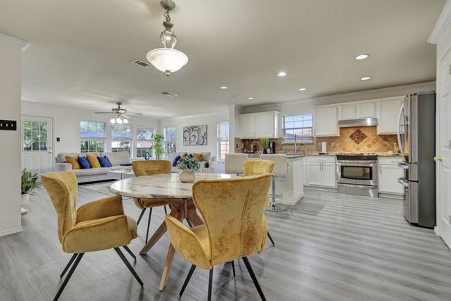 Dining room featuring ceiling fan, a wealth of natural light, and light hardwood / wood-style flooring | Image 12