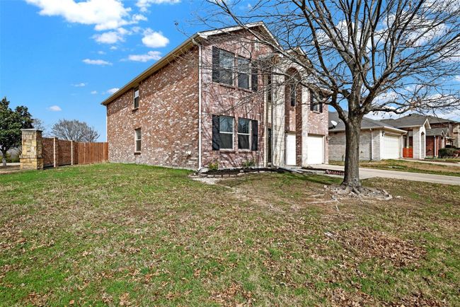 View of home's exterior featuring brick siding and concrete driveway | Image 35