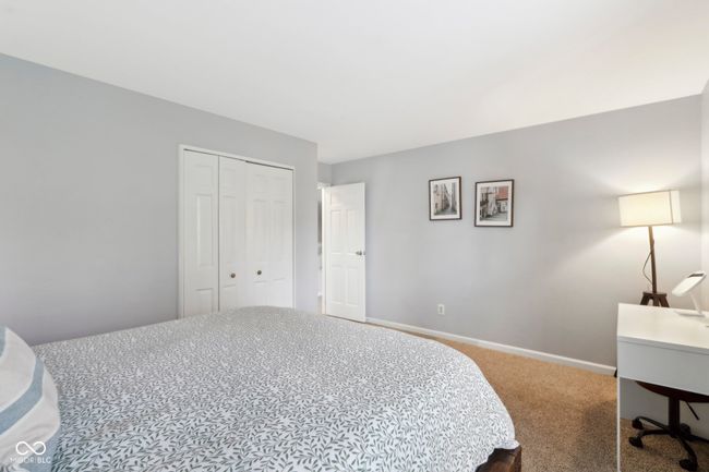 bedroom featuring baseboards, carpet flooring, and a closet | Image 15