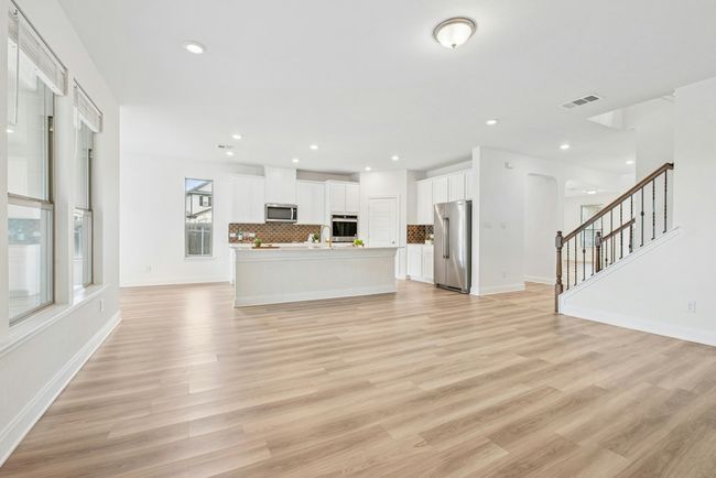 Kitchen open to casual living area. | Image 10