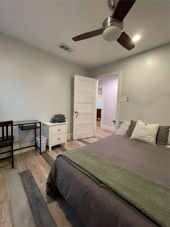 Bedroom featuring light wood-style floors and a ceiling fan | Image 21