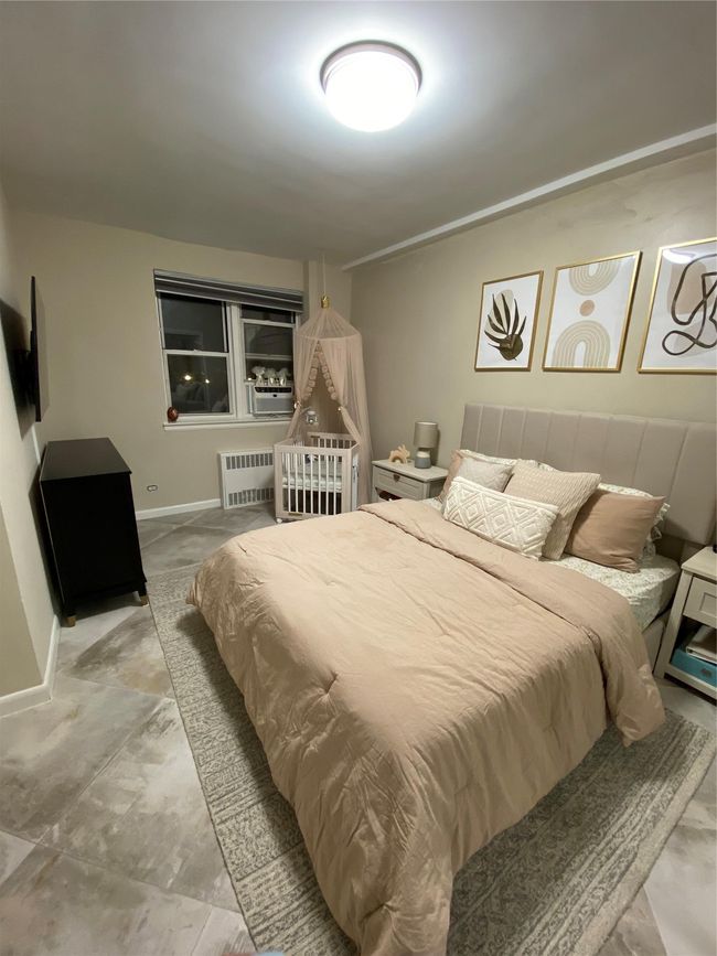 Bedroom with radiator heating unit and baseboards | Image 5