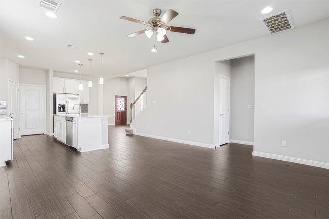 Kitchen with recessed lighting, light countertops, a ceiling fan, dark wood-style flooring, and open floor plan | Image 16