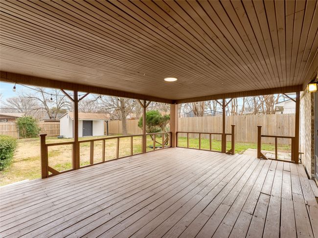 Wooden deck with a storage shed and a lawn | Image 27