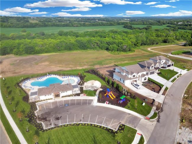 Aerial view of a pool area and a heavily wooded area | Image 22