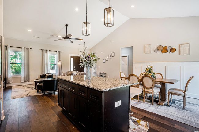 Kitchen with ceiling fan, dark wood-style floors, decorative light fixtures, a center island, and recessed lighting | Image 7