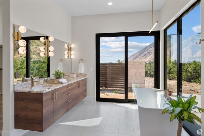 Full bathroom with a soaking tub, double vanity, a mountain view, and tile patterned flooring | Image 43