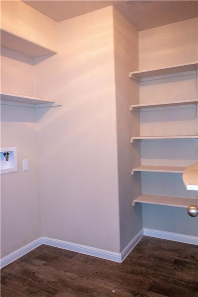 Washroom featuring dark wood finished floors and hookup for a washing machine | Image 20