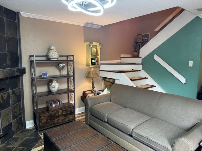 Living room with stairs and crown molding | Image 4