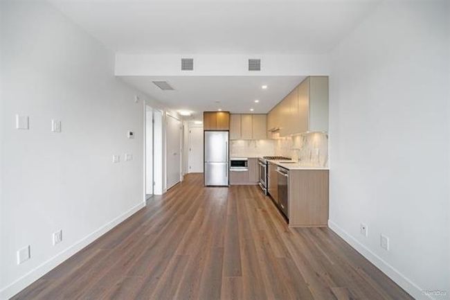 Kitchen with appliances with stainless steel finishes, light countertops, dark wood-style flooring, tasteful backsplash, and recessed lighting | Image 7