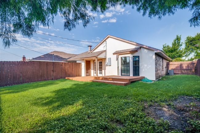 Back of property featuring stucco siding, a fenced backyard, a wooden deck, and french doors | Image 28