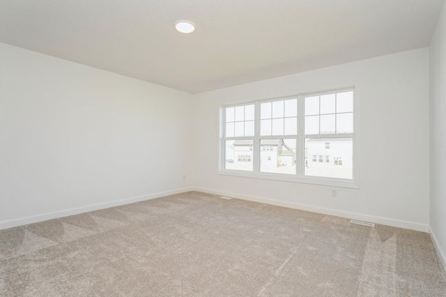 Photo is of the actual home. Find your retreat in this stunning primary bedroom. Enjoy the exclusivity of a private bath and huge walk-in closet. | Image 13