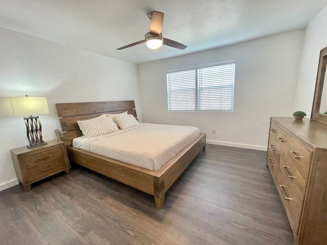Bedroom featuring dark wood-style flooring and a ceiling fan | Image 6