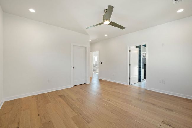 Empty room with baseboards, ceiling fan, light wood finished floors, and recessed lighting | Image 26