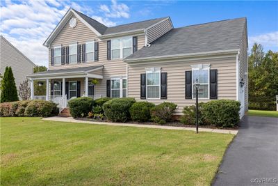 View of front of house with covered porch and a front yard | Image 1