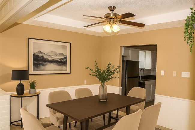 Dining space with a ceiling fan and a textured ceiling | Image 8