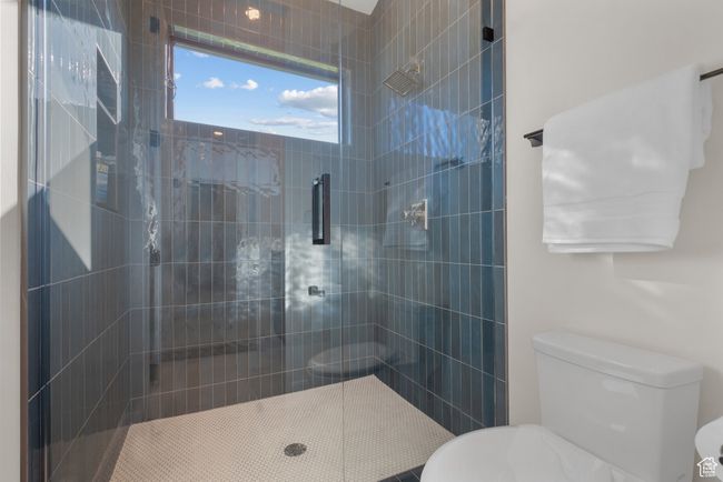 Full bath featuring toilet and tiled shower | Image 50