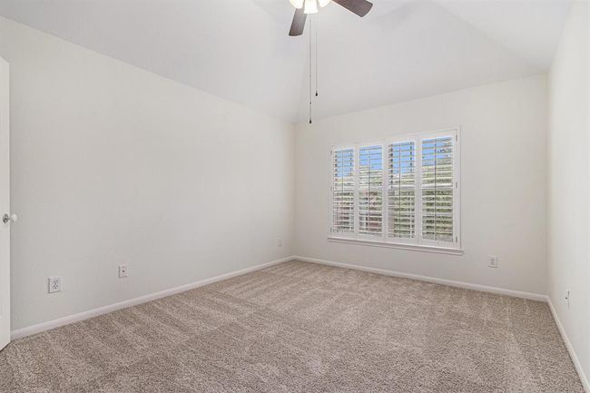 This room has vaulted ceilings and views of the trees! | Image 34