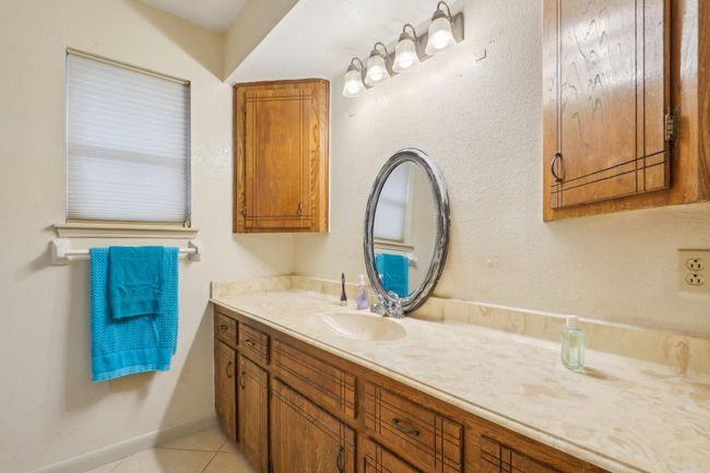 Primary bathroom features ample counter space and a shower/tub combo. | Image 13