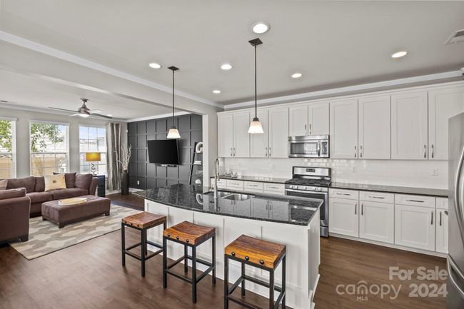 Bright kitchen with oversized island, stainless steel appliances & walk-in pantry. | Image 10