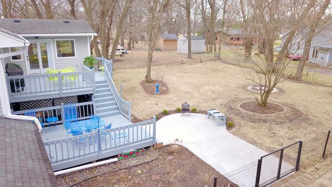 Deck leads to concrete patio | Image 27