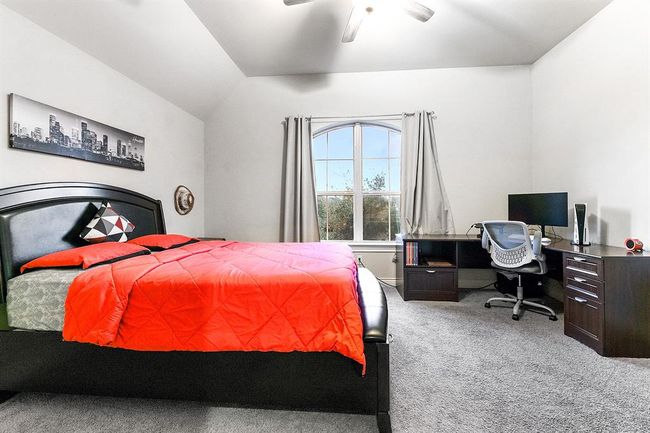 Upstairs, you'll find three large bedrooms, including this junior en suite. It features a private attached bathroom, providing added privacy and convenience. The room is spacious enough to comfortably fit a large queen bed and includes an L-shaped desk with plenty of extra room. | Image 32
