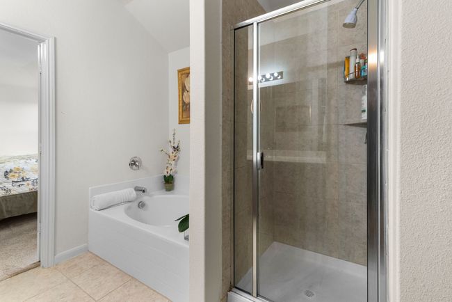 Full bath with a shower stall, a bath, tile patterned floors, and ensuite bathroom | Image 29