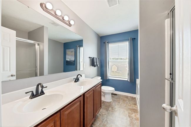 Primary bathroom with double vanity. | Image 24