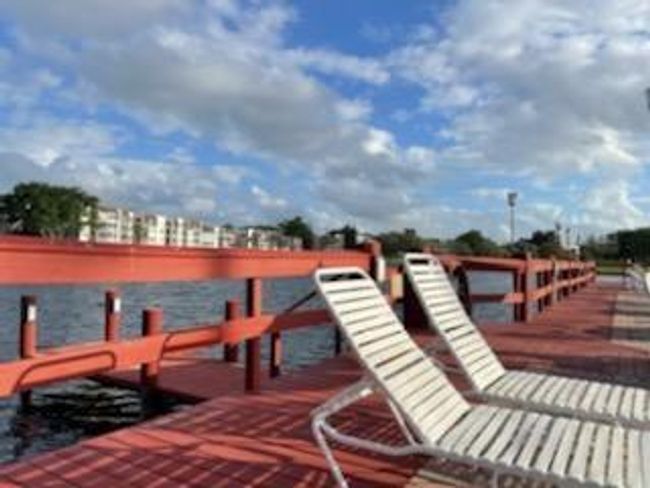 Clubhouse Pool Area Overlooking Lake and Water Fountain | Image 34