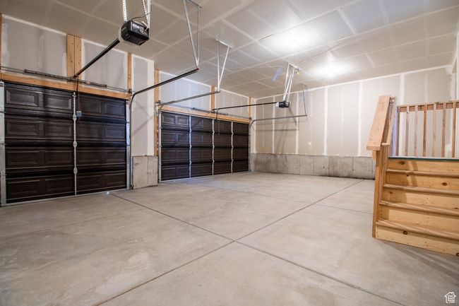 Garage featuring a garage door opener.*Photo in picture is similar to the home being built | Image 10