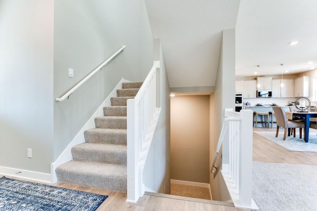 Time to head downstairs to the FINISHED lower-level recreation room! Photo of model home, color and options will vary. | Image 34